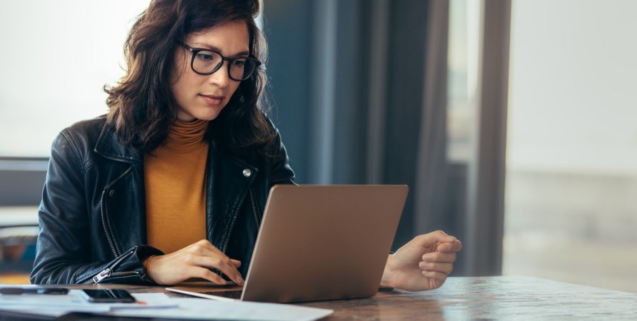Woman sitting at a computer.